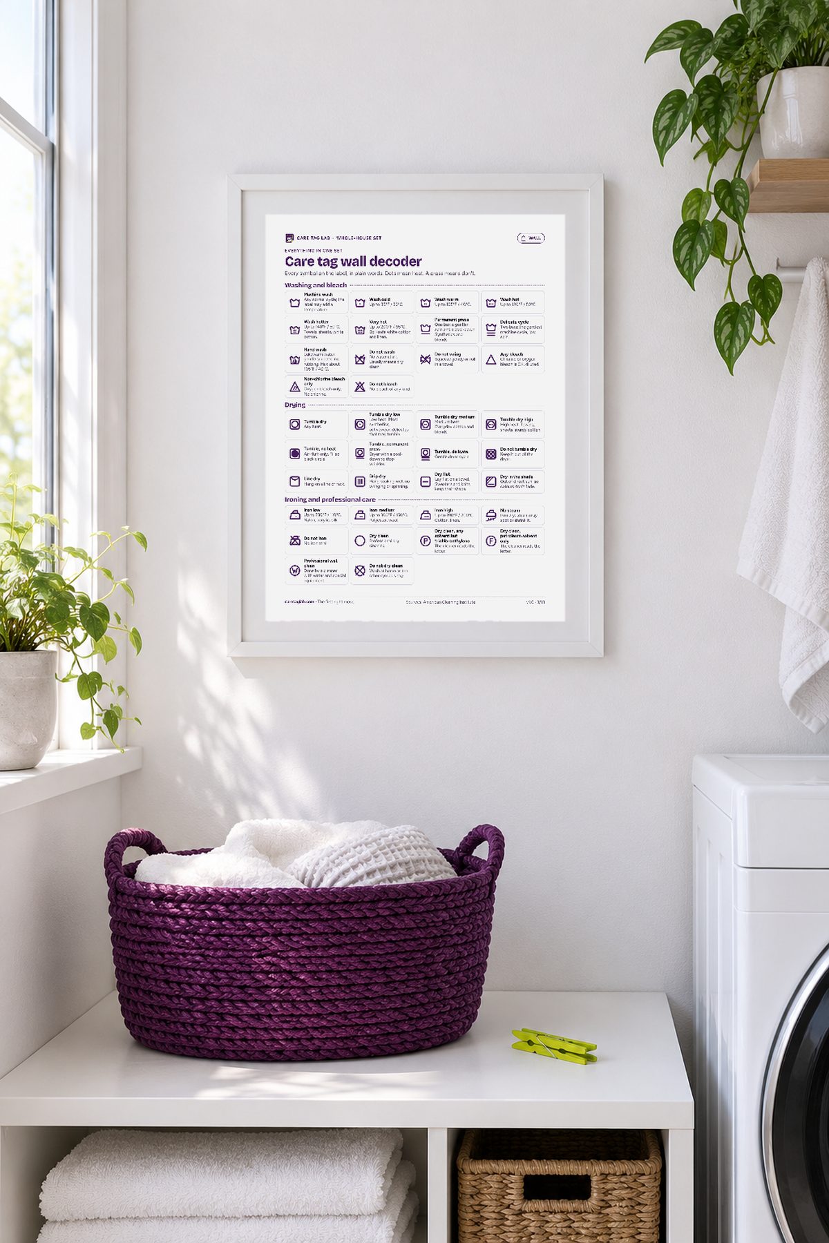 A white frame on a bright laundry room wall above a shelf with a purple basket.